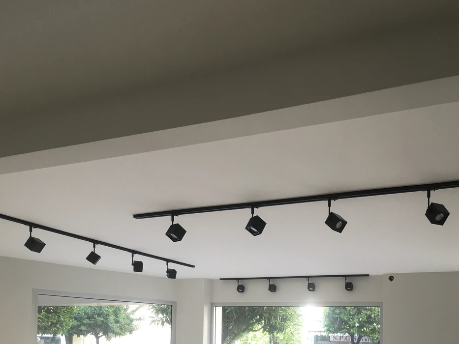 Plafond commercial équipé de rails d'éclairage noir mat fixés en saillie